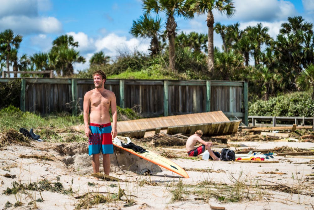 Jake Turner, a 25-year-old Jacksonville local, laughs off a crash after surfing at Ponte Vedra Beach on Saturday.