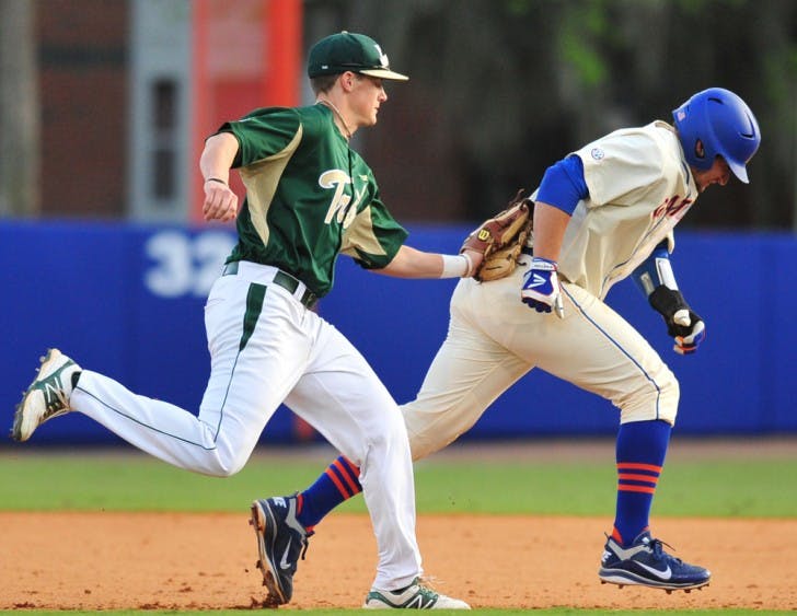 William &amp; Mary shortshop Ryan Williams (left) tags Florida catcher Mike Zunino (right) during a rundown in Saturday’s game, a 5-1 UF win. Zunino injured his hamstring during the play.