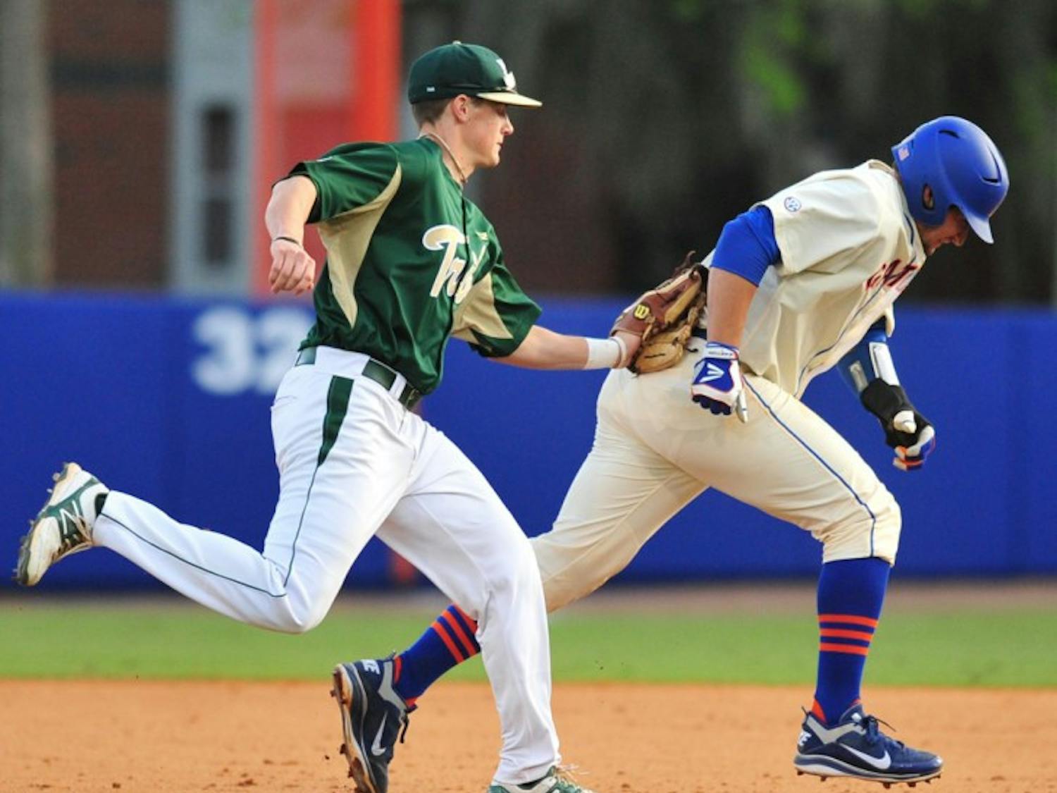William & Mary shortshop Ryan Williams (left) tags Florida catcher Mike Zunino (right) during a rundown in Saturday’s game, a 5-1 UF win. Zunino injured his hamstring during the play.