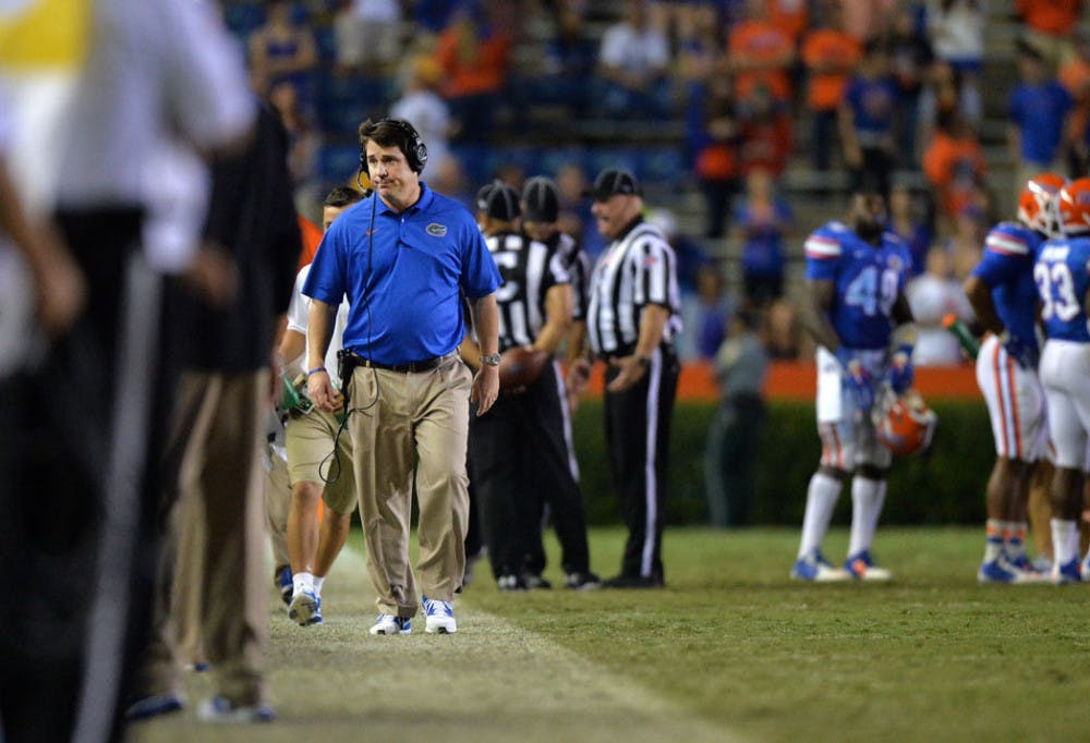 <p>Florida head coach Will Muschamp walks down the sideline during Florida's 42-13 loss to Missouri on Saturday at Ben Hill Griffin Stadium.</p>