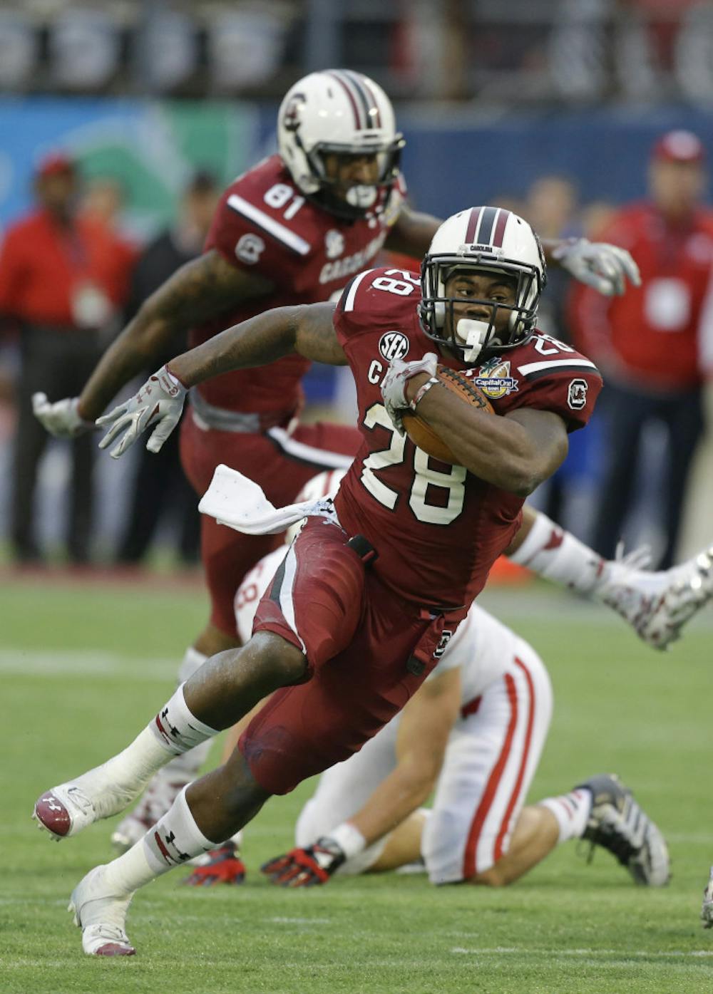 <p>In this Jan. 1, 2014, file photo, South Carolina running back Mike Davis (28) gains yardage against Wisconsin during the second half of the Capital One Bowl NCAA college football game in Orlando, Fla. Steve Spurrier says 1,000-yard rusher Mike Davis hadn't practiced last week and might not be ready when the ninth-ranked Gamecocks open the season against No. 21 Texas A&amp;M tonight.</p>