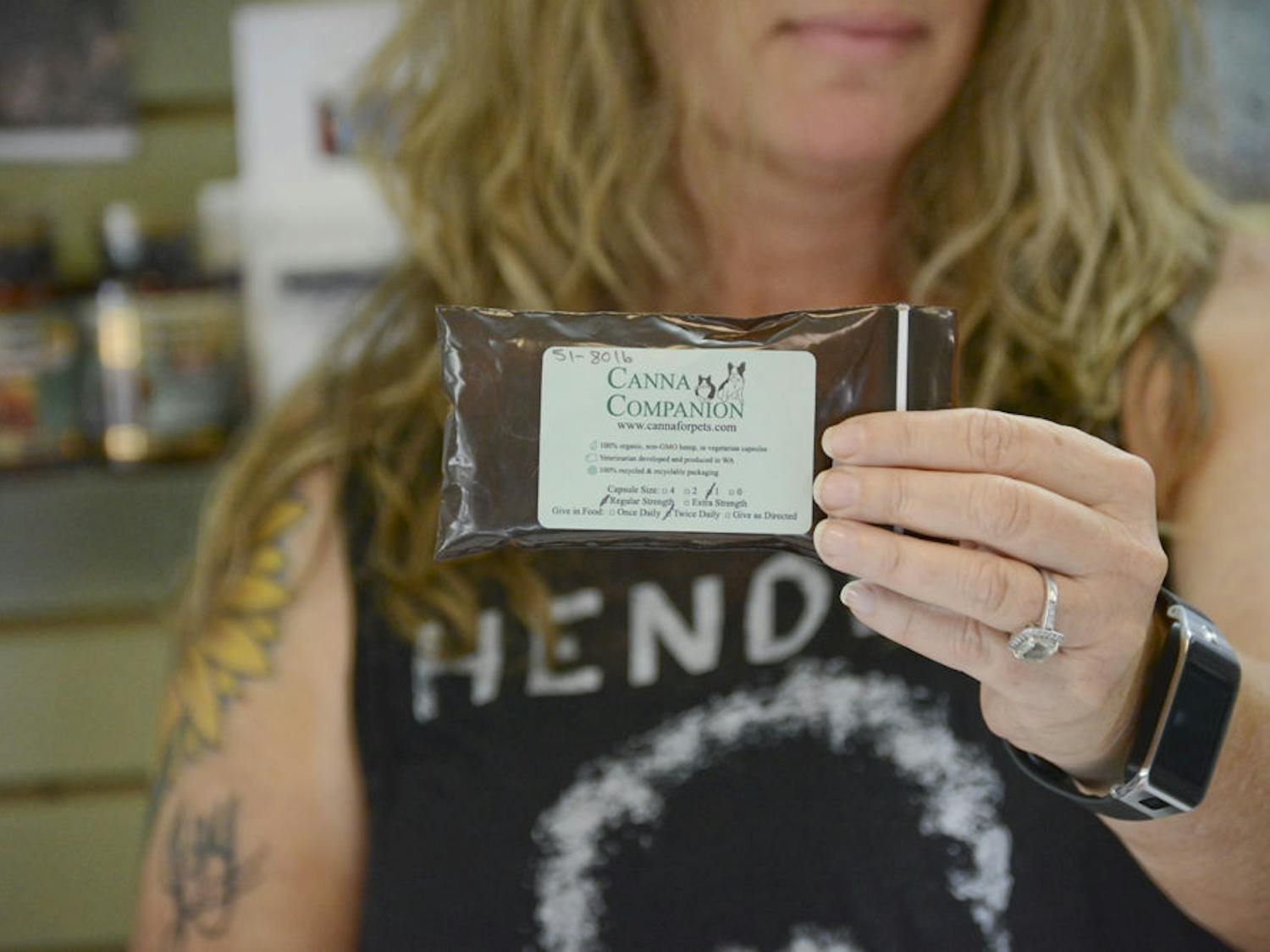 Kat Drawdy, 44, holds up a package of Canna Companion, a hemp-based supplement for pets. Drawdy and her partner, Joy, own the local pet store Earth Pets. The sale of the product touched off a controversy over the legality of hemp in Florida.