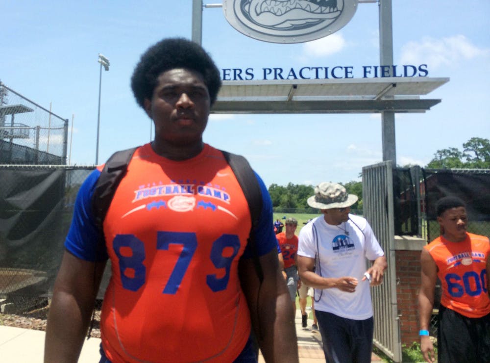 <p>Three-star offensive tackle Jalen Merrick walks off of the Sanders Practice Fields on Saturday. Merrick has been committed to UF since January.</p>