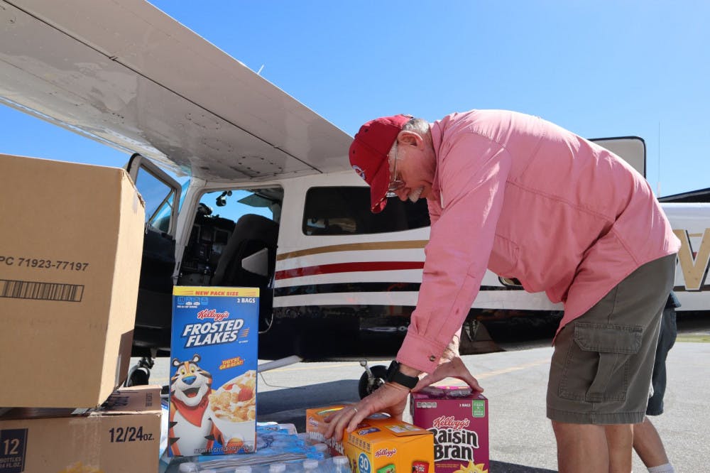 Pilot Mark Creighton, of Port Aransas, Texas, loads nonperishable food onto a plane headed to Appalachia, Florida, for Operation Airdrop. His home flooded during Hurricane Harvey, and he’s helped other victims of hurricanes through Operation Airdrop since.