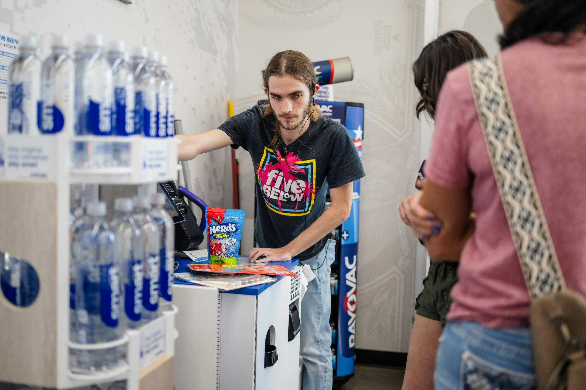 Five Below worker Riley Long assists a customer during checkout in Gainesville, Florida on Sept. 28, 2024.