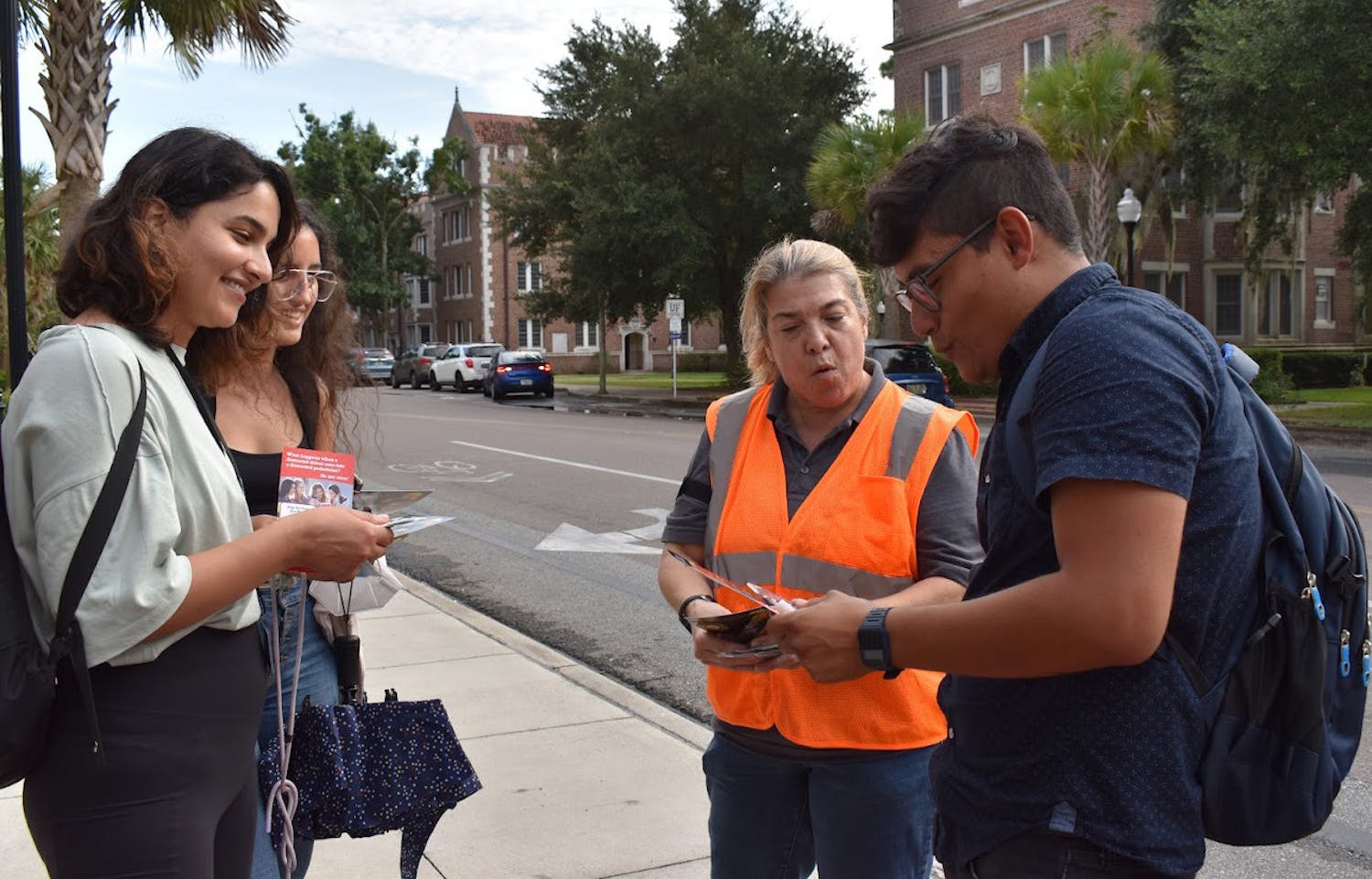 Paula Gonzalez, FDOT communication staff member, talks to students about pedestrian safety outside the UF chemistry building on Buckman Drive on Thursday, Aug. 26, 2021. (Photo by Elena Barrera)