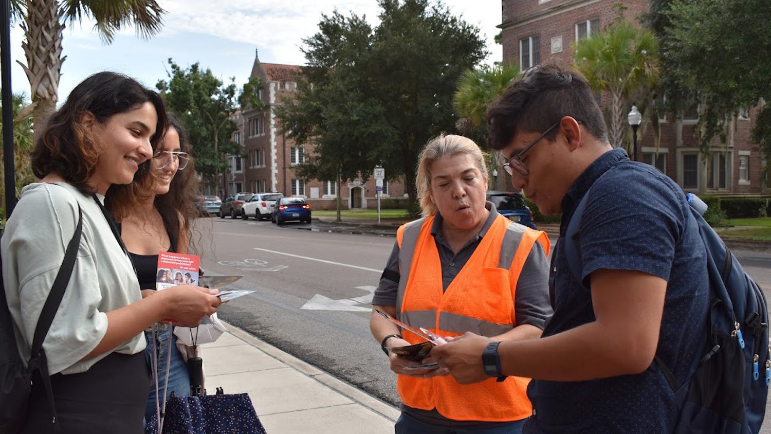 Paula Gonzalez, FDOT communication staff member, talks to students about pedestrian safety outside the UF chemistry building on Buckman Drive on Thursday, Aug. 26, 2021. (Photo by Elena Barrera)
