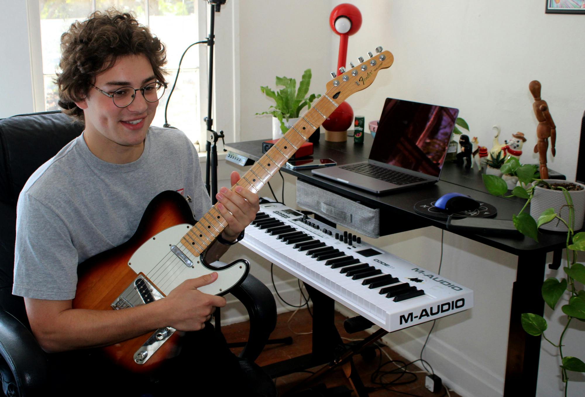 Shane Malone, a Gainesville-based recording artist, plays his guitar in his home music studio on Wednesday, March 2. His new single "Waiting," dropped on music streaming services on March 4.