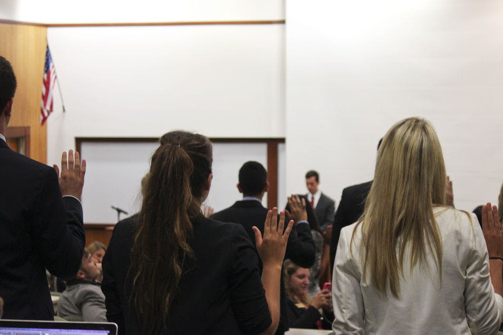 Members of the new 2014-2015 UF Student Senate are sworn in at Tuesday’s meeting.