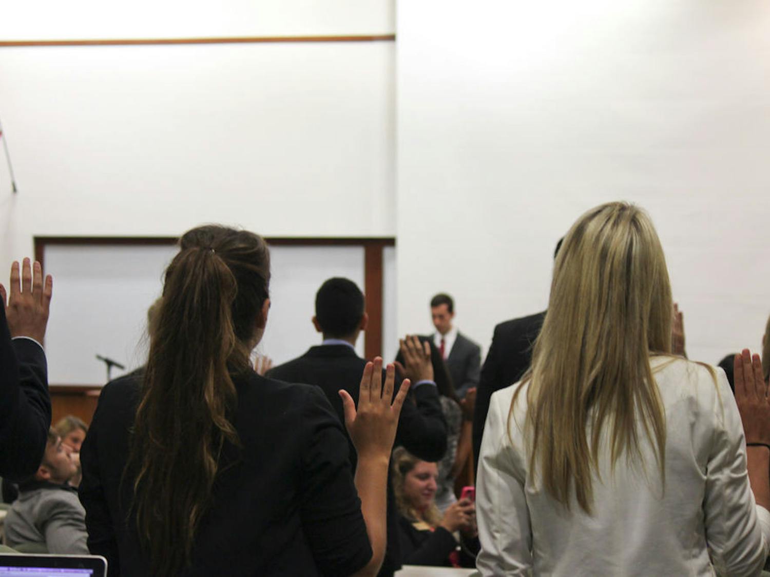 Members of the new 2014-2015 UF Student Senate are sworn in at Tuesday’s meeting.