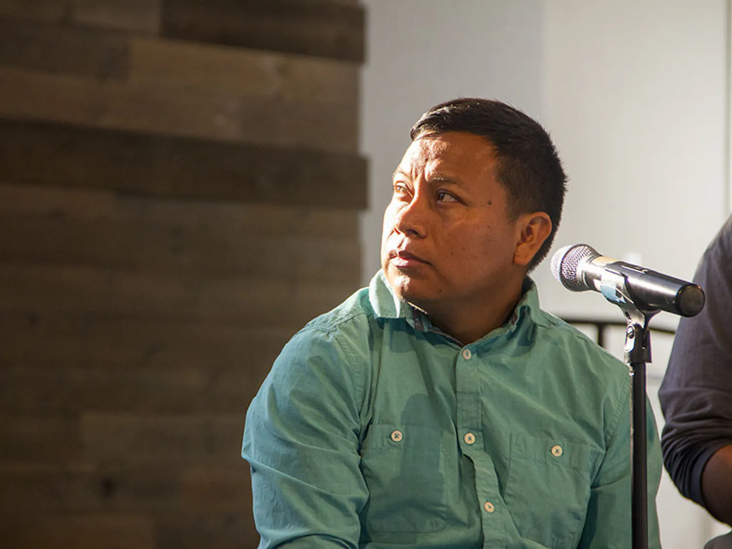 Representative for the Coalition for Immokalee Workers Oscar Otzoy watches a video Tuesday depicting the injustices faced by local farmers. The Coalition for Immokalee Workers is instituting a ban on Wendy's because they believe the company does not provide its farmworkers a livable wage and humane working conditions.