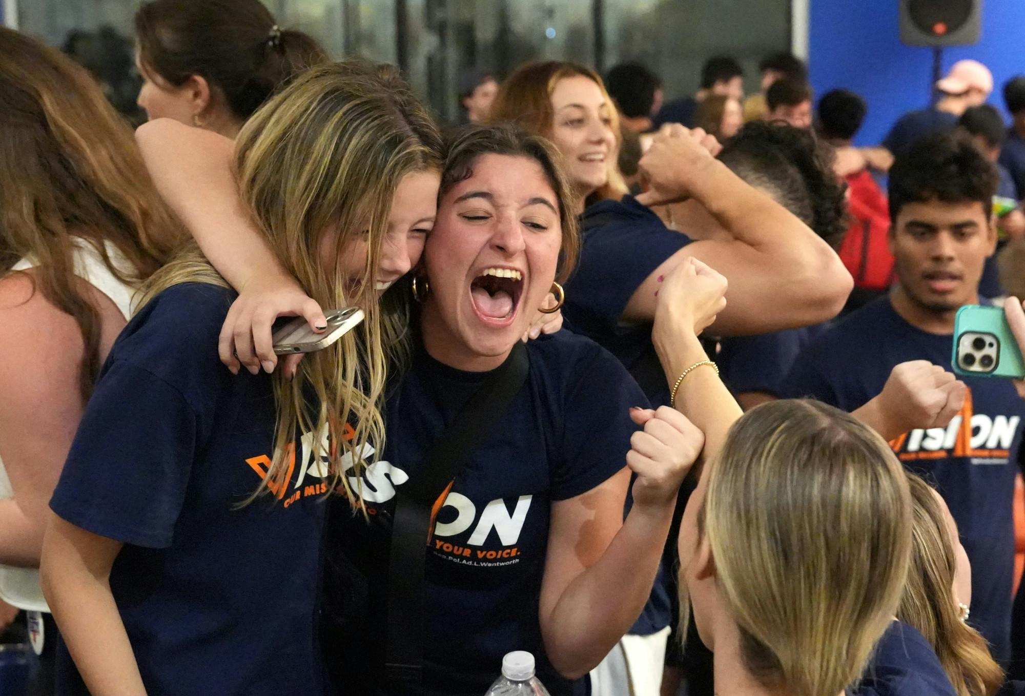 Members of Vision Party scream with joy over their election victory on Wednesday, Oct. 4, 2023. 