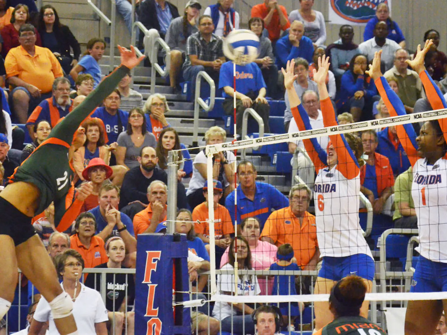 Mackenzie Dagostino (6) and Rhamat Alhassan (1) attempt to block a kill attempt during No. 8 seed Florida's 3-1 win against Miami in the second round of the NCAA Tournament on Saturday in the O'Connell Center.