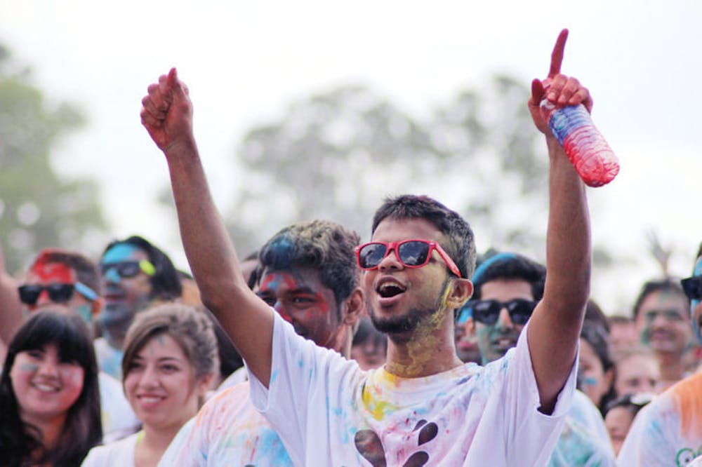 <p class="p1">Sarim Zaidi, a 24-year-old UF computer science graduate student, cheers at the festival on Flavet Field. Holi is observed to celebrate spring.&nbsp;</p>