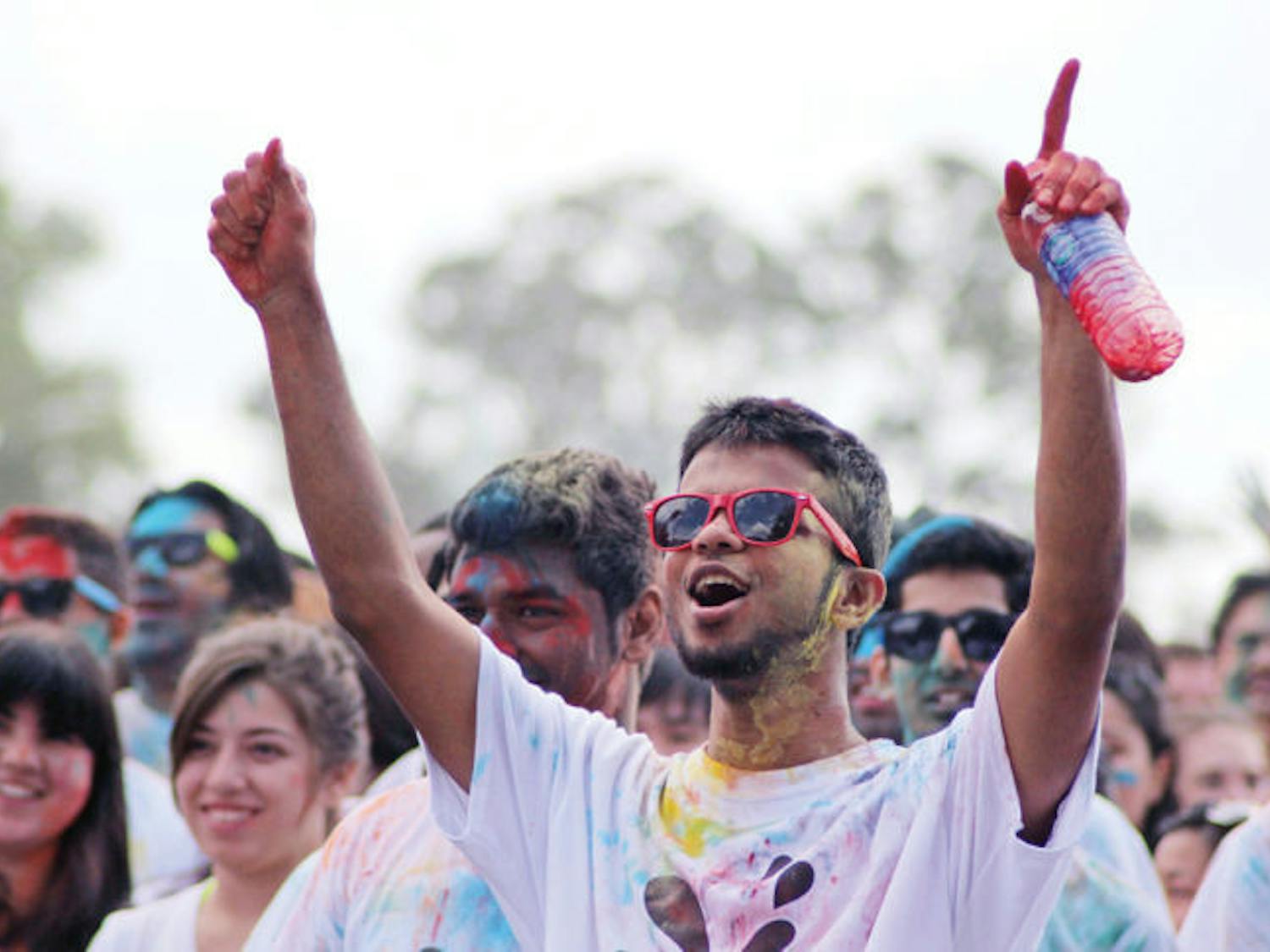Sarim Zaidi, a 24-year-old UF computer science graduate student, cheers at the festival on Flavet Field. Holi is observed to celebrate spring. 