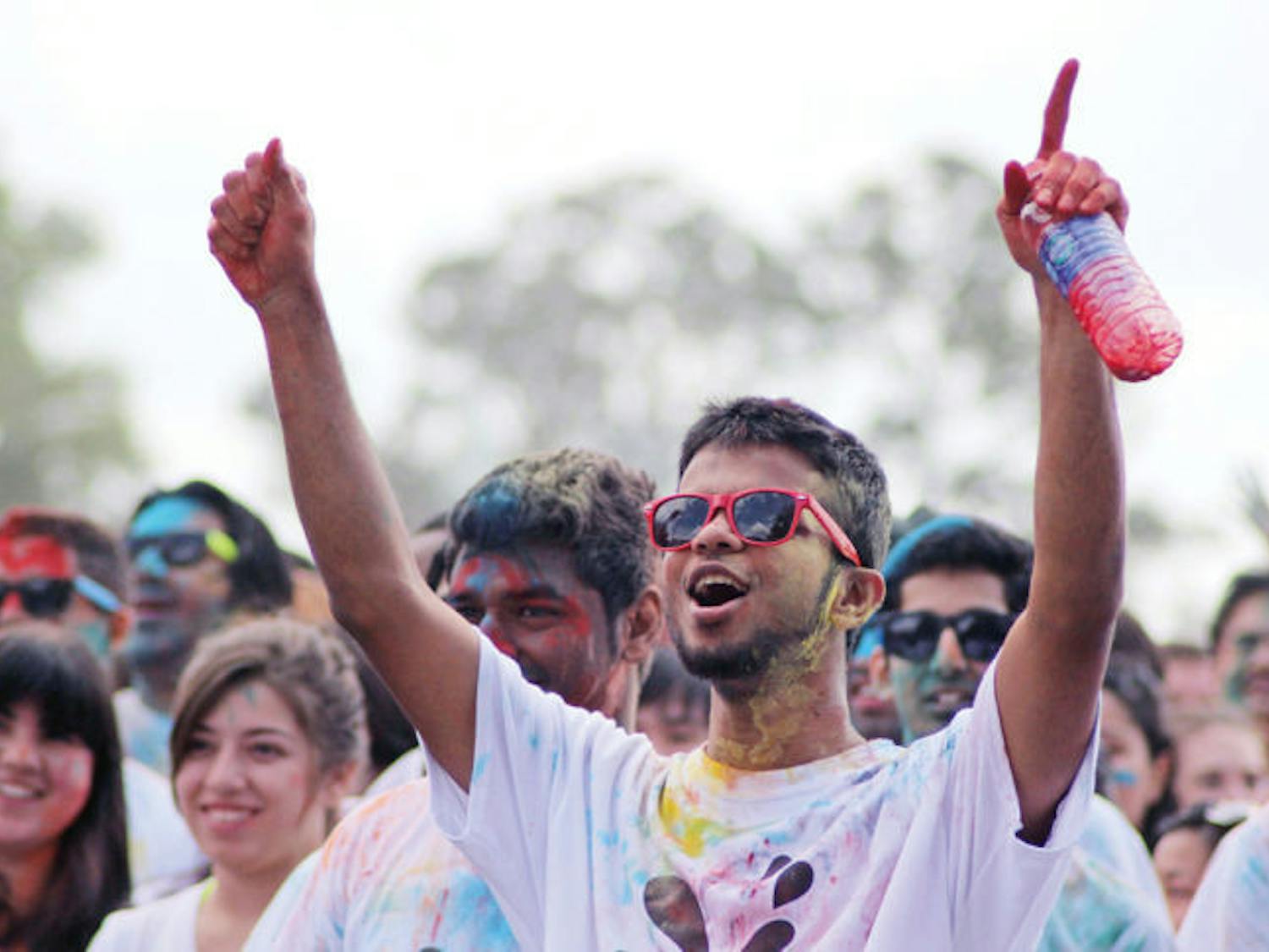 Sarim Zaidi, a 24-year-old UF computer science graduate student, cheers at the festival on Flavet Field. Holi is observed to celebrate spring.&nbsp;