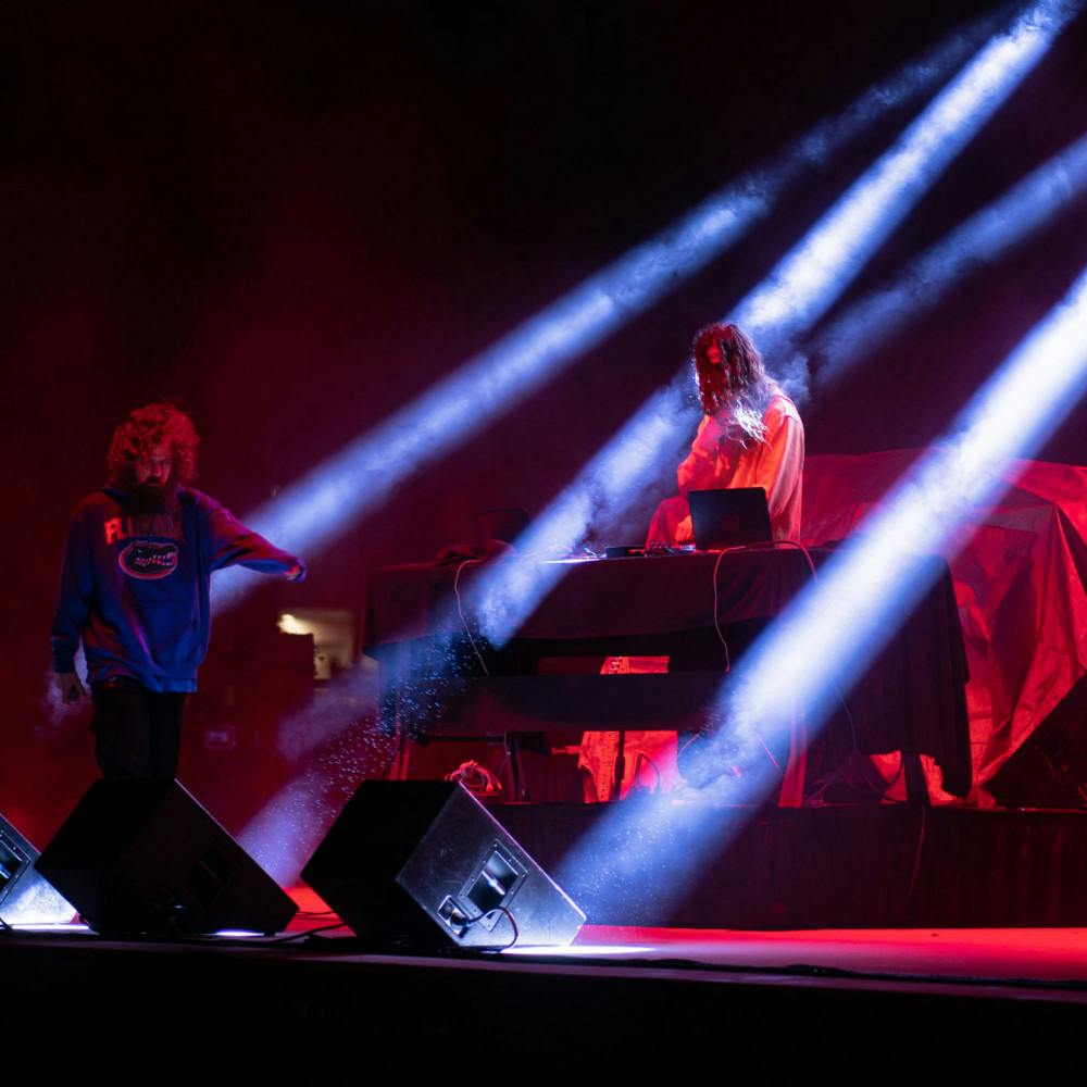 Brothers Kevin and Jeff Saurer perform underneath the lights at Flavet Field as the duo Hippie Sabotage, the opening act for the Fall concert Friday night.