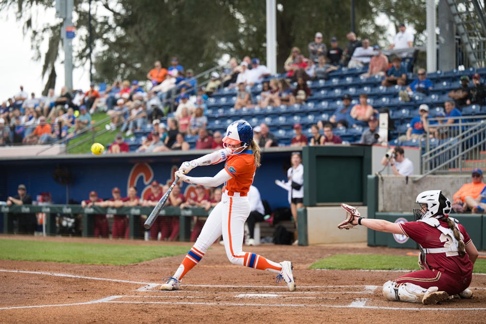 Florida Gators outfielder Taylor Shumaker (21) hits the ball in a softball game against Boston College in Gainesville, Fla., on Saturday, Feb. 15, 2025.