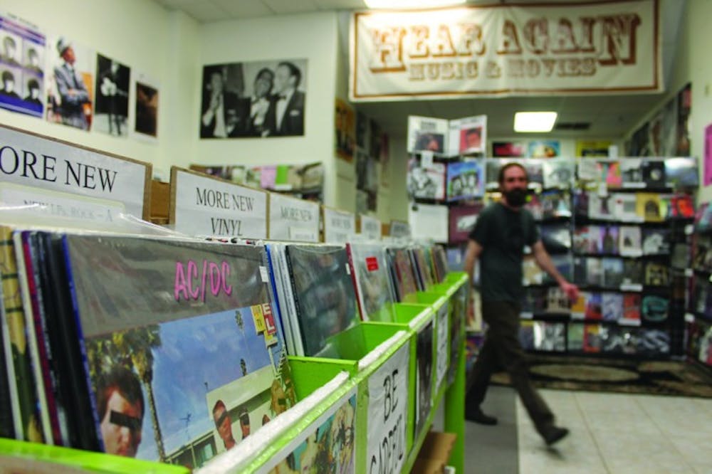 <p>Andrew Schaer owner of Hear Again Music and Movies, returns from helping a customer. Hear Again Music and Movies is one of three surviving record stores in Gainesville, along with Hyde &amp; Zeke Records and Wayward Council.</p>