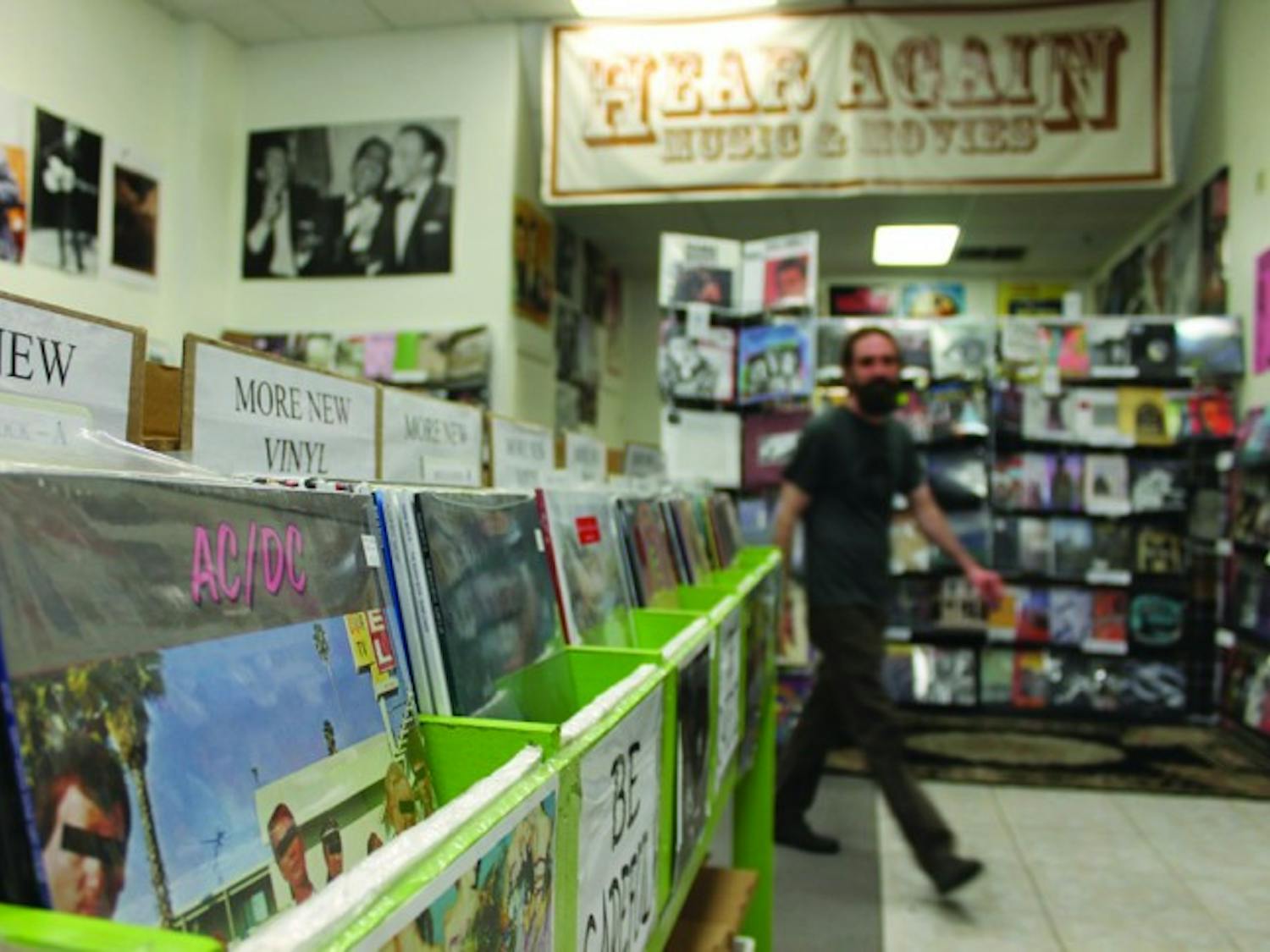Andrew Schaer owner of Hear Again Music and Movies, returns from helping a customer. Hear Again Music and Movies is one of three surviving record stores in Gainesville, along with Hyde &amp; Zeke Records and Wayward Council.