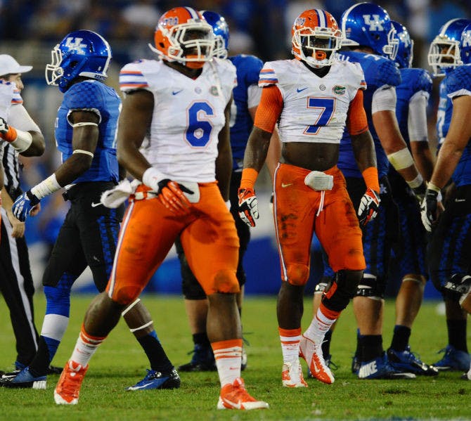 Dante Fowler Jr. (6) and Ronald Powell (7) celebrate after a play during Florida’s 24-7 victory against Kentucky on Saturday in Commonwealth Stadium in Lexington, Ky.