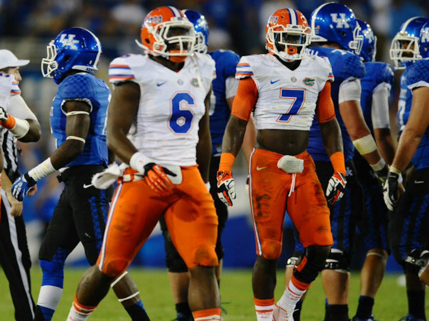 Dante Fowler Jr. (6) and Ronald Powell (7) celebrate after a play during Florida’s 24-7 victory against Kentucky on Saturday in Commonwealth Stadium in Lexington, Ky.
