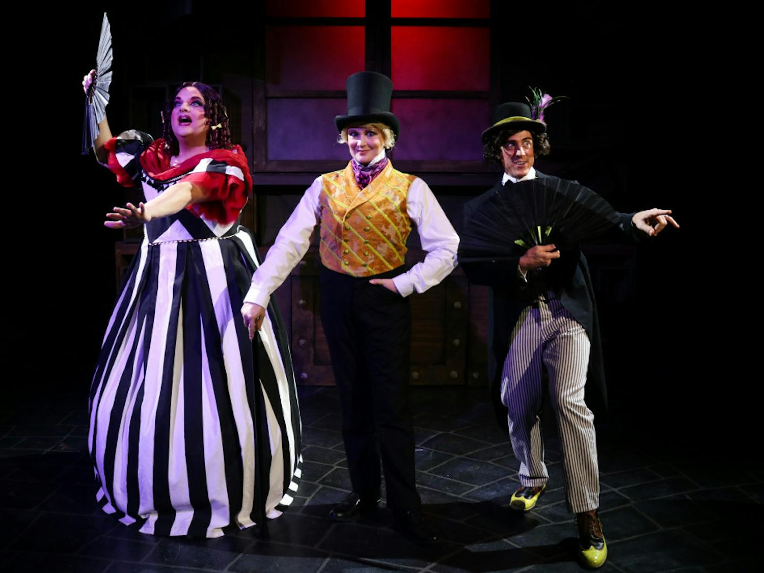 Actors Matthew McGee, Kelly Atkins and David Patrick Ford take center stage in costume for their roles in the Hippodrome's "Scrooge in Rouge."
