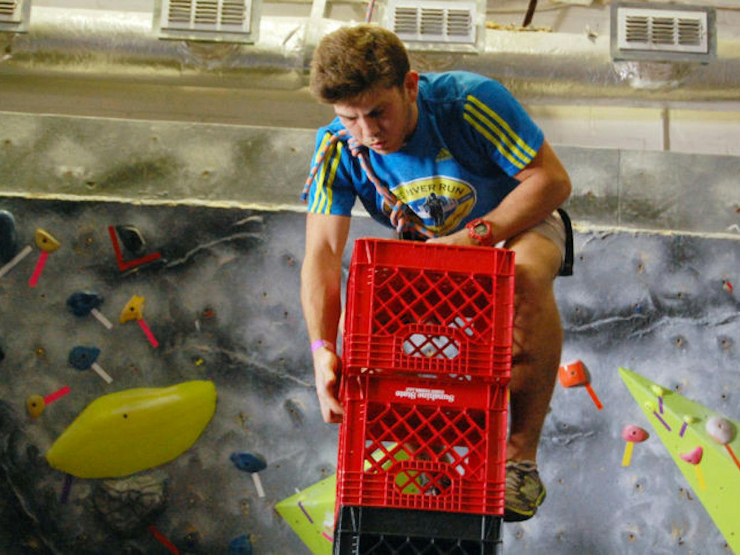 Zachary Mersal, a 22-year-old UF information systems junior, balances Saturday during the crate stacking competition at Gainesville Rock Gym.