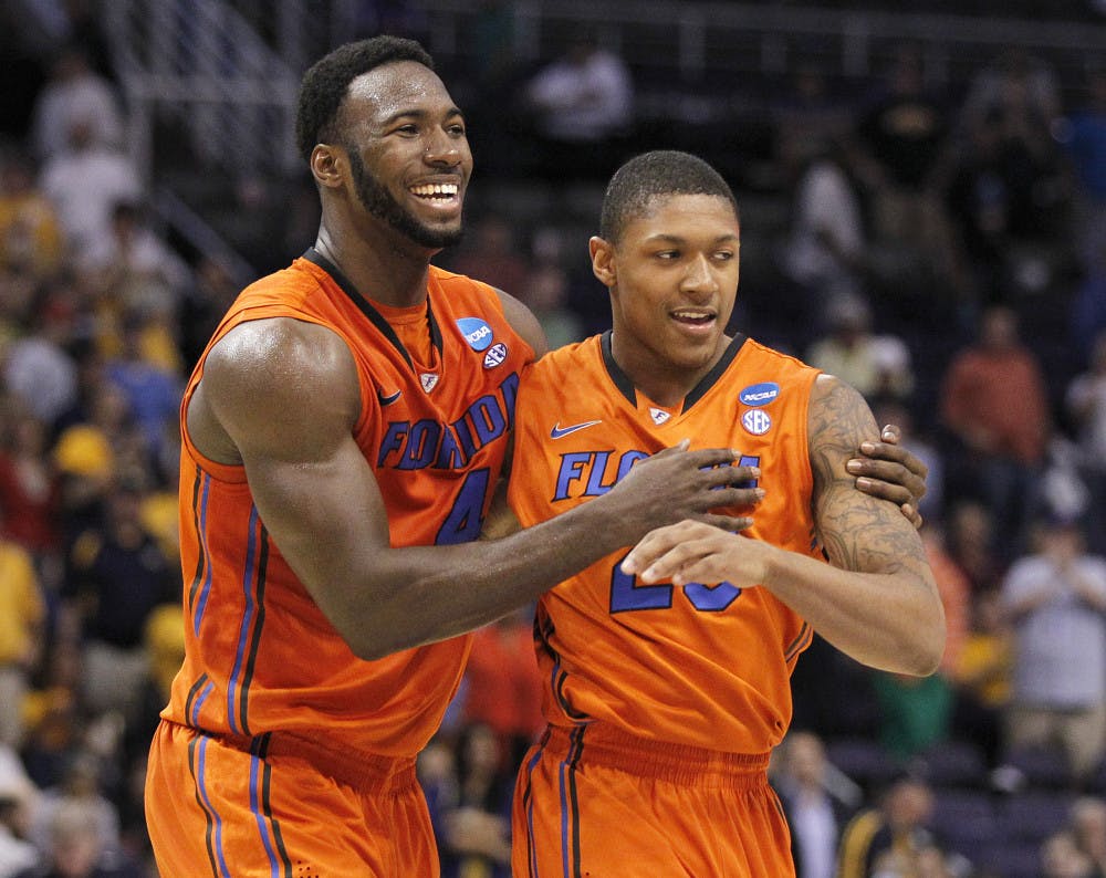 <p>Florida center Patric Young embraces guard Brad Beal during the team’s Sweet 16 meeting with Marquette in 2012.</p>