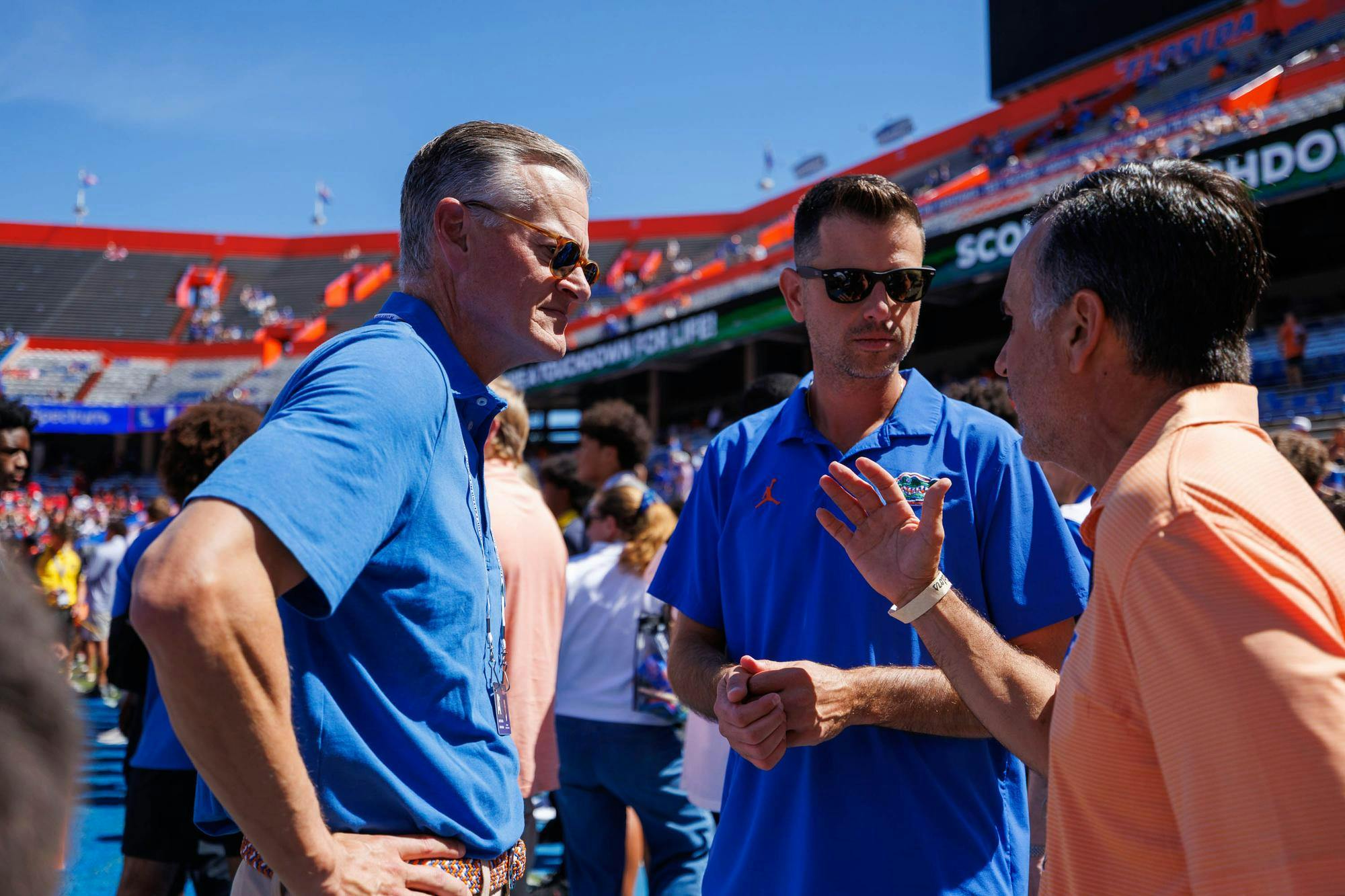 Florida athletic director Scott Stricklin (left) and Florida basketball head coach Todd Golden (middle) speak together on the Florida field before an NCAA college football game against Ole Miss, Saturday, Sept. 26, 2026, in Gainesville, Fla.