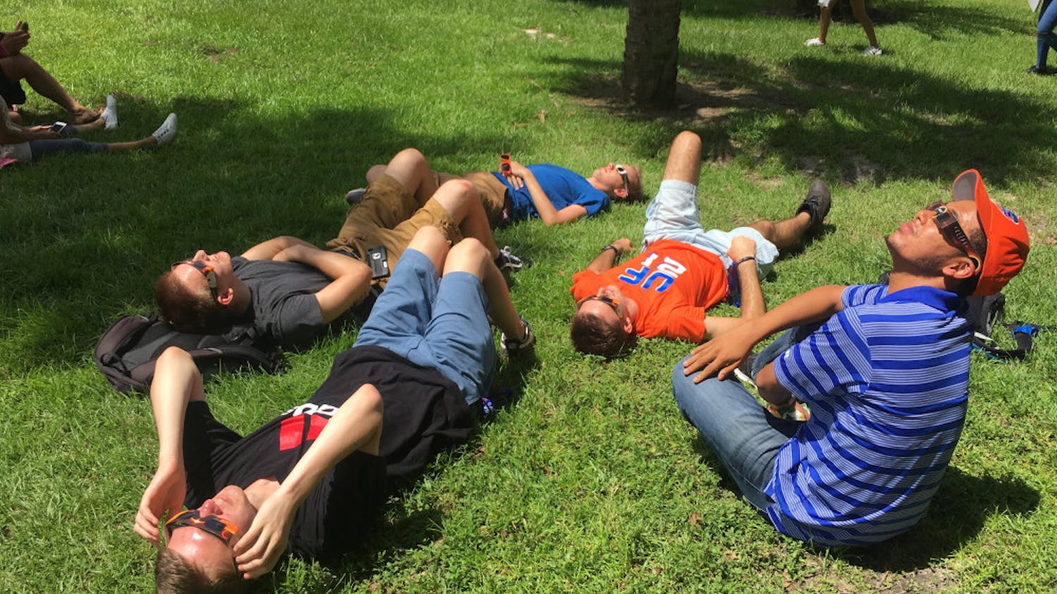 A group of UF students observes the eclipse near the New Physics Building. The eclipse lasted from 1:15 p.m. to 4:11 p.m.