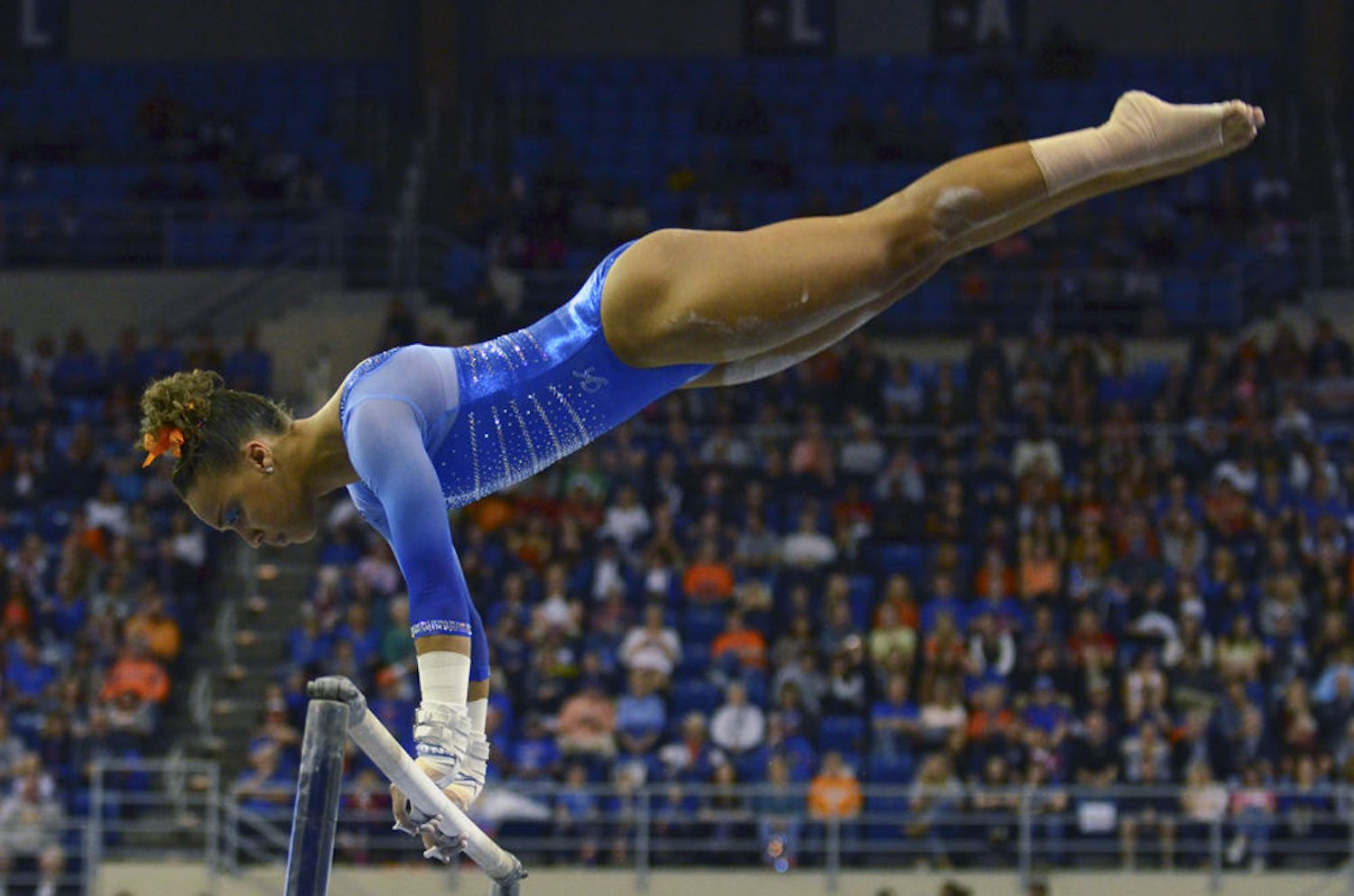 Kytra Hunter performs on the uneven parallel bars during Florida's 197.60-196.950 win against Georgia on Friday in the O'Connell Center.
