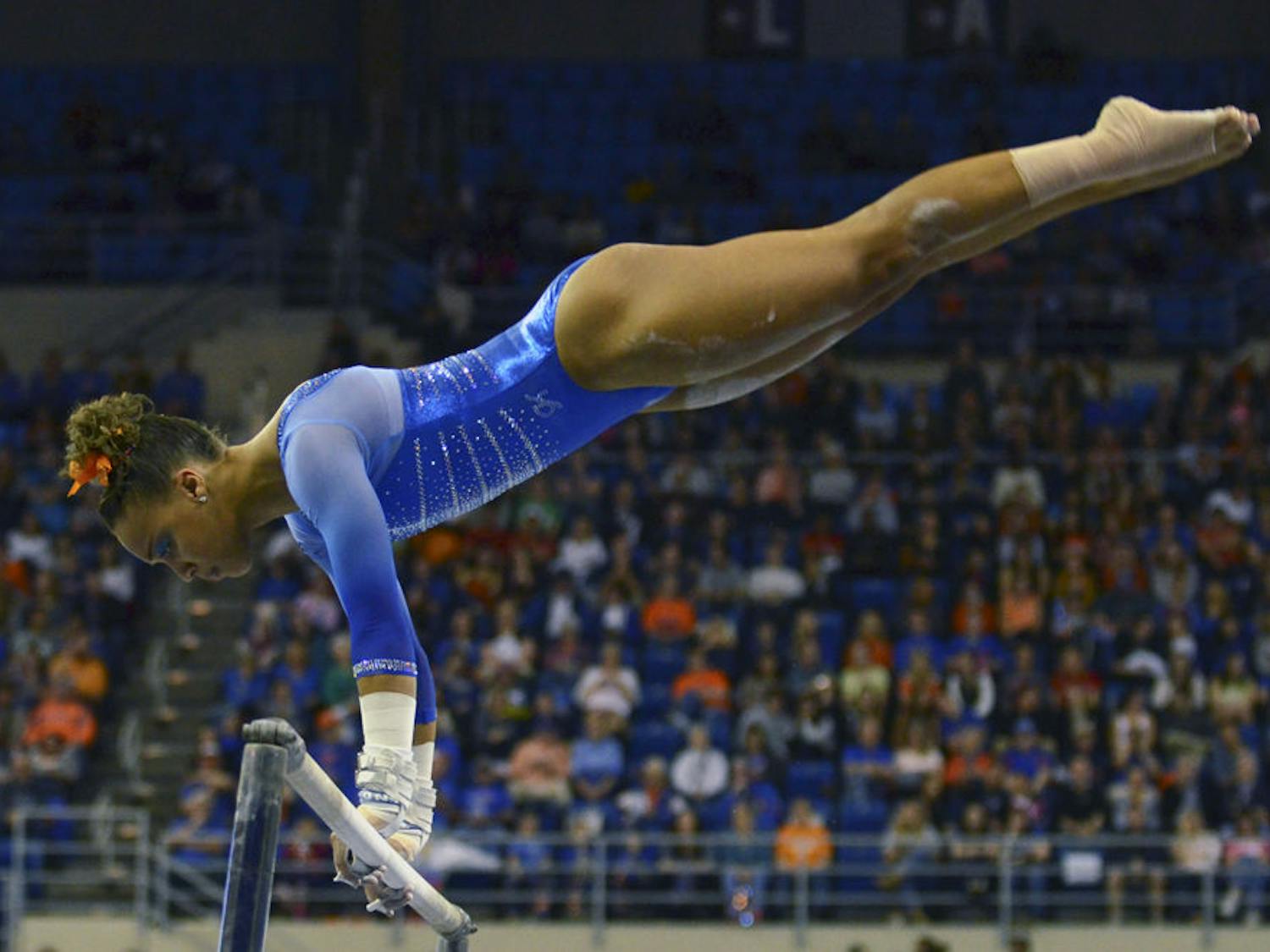 Kytra Hunter performs on the uneven parallel bars during Florida's 197.60-196.950 win against Georgia on Friday in the O'Connell Center.