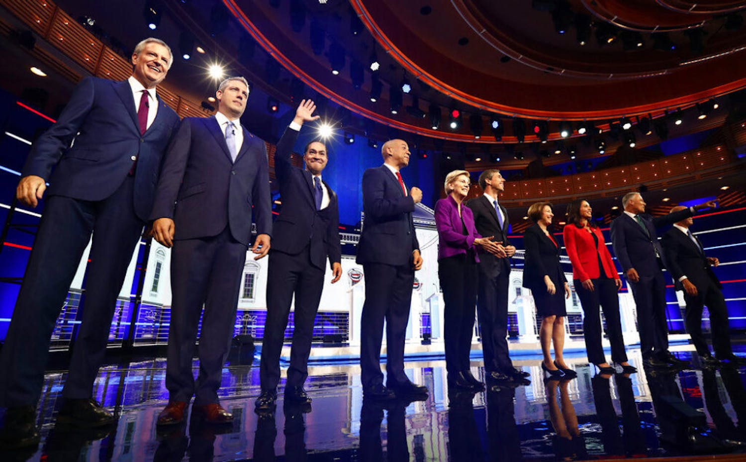 From left, New York City Mayor Bill de Blasio, Rep. Tim Ryan, D-Ohio, former Housing and Urban Development Secretary Julian Castro, Sen. Cory Booker, D-N.J., Sen. Elizabeth Warren, D-Mass., former Texas Rep. Beto O’Rourke, Sen. Amy Klobuchar, D-Minn., Rep. Tulsi Gabbard, D-Hawaii, Washington Gov. Jay Inslee, and former Maryland Rep. John Delaney pose for a photo on stage before the start of a Democratic primary debate hosted by NBC News at the Adrienne Arsht Center for the Performing Arts, Wednesday, June 26, 2019, in Miami.
