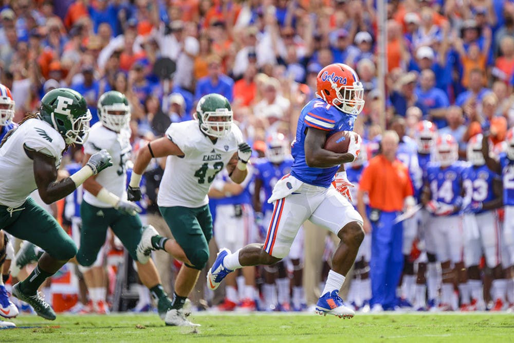 <p><span>Kelvin Taylor runs 31 yards for a touchdown in the first quarter of Florida’s 65-0 win over Eastern Michigan on Saturday.</span></p>