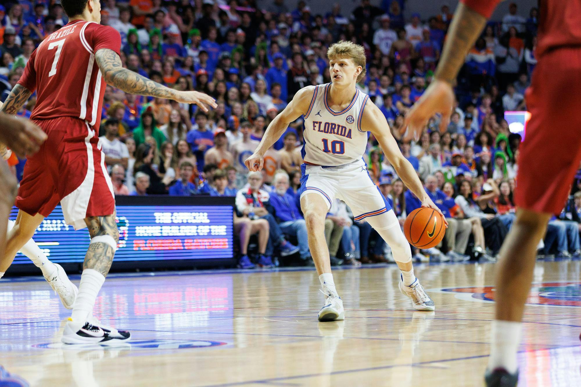 Florida forward Thomas Haugh (10) dribbles the ball during the first half of an NCAA basketball game against Arkansas, Saturday, Feb.28, 2026, in Gainesville, Fla.