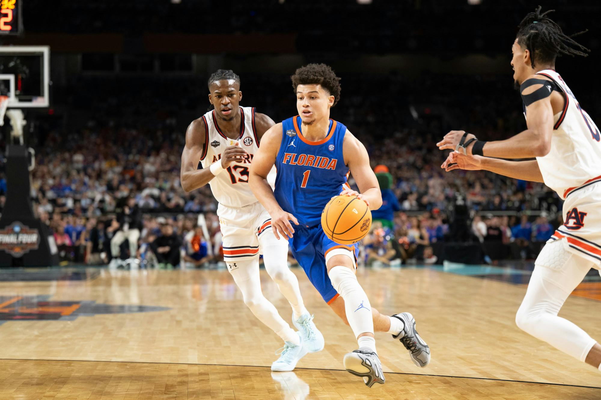 Florida Gators guard Walter Clayton Jr. (1) drives with the ball during a basketball game against the Auburn Tigers in the Final Four round of the NCAA Tournament on Saturday, April 5, 2025, in San Antonio, Texas.