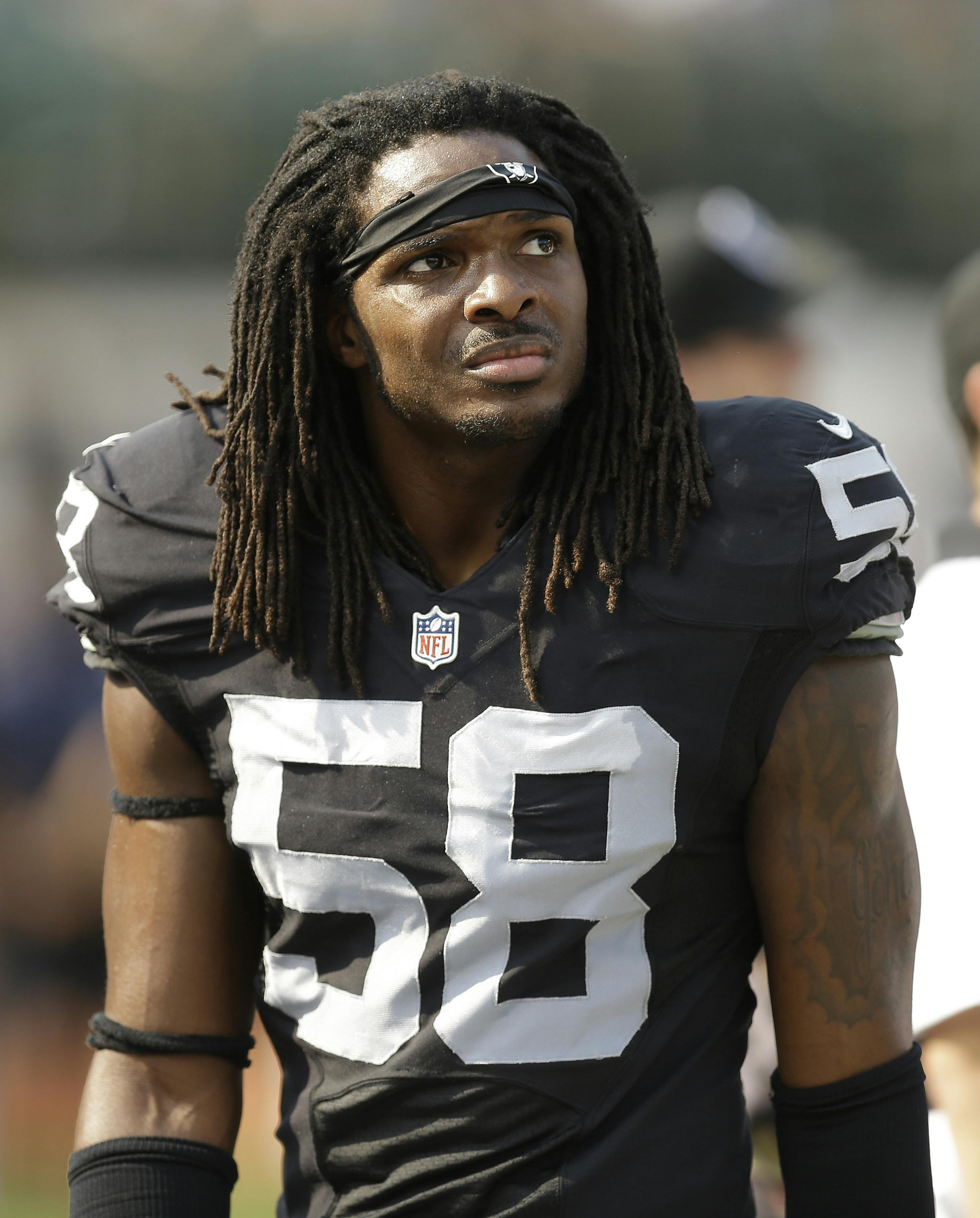 In this Sunday, Sept. 13, 2015 photo, Oakland Raiders outside linebacker Neiron Ball (58) stands on the sideline during the second half of an NFL football game against the Cincinnati Bengals in Oakland, Calif. Former Oakland Raiders linebacker Neiron Ball, who played college football at Florida after recovering from brain surgery, has died. He was 27.(AP Photo/Ben Margot)