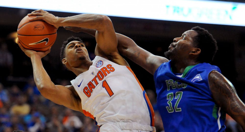 <p>Florida forward Devin Robinson fights for a shot against Florida Gulf Coast forward Antravious Simmons during the first half of an NCAA college basketball game, Friday Nov. 11, 2016, in Jacksonville, Fla. (Bob Mack/The Florida Times-Union via AP)</p>