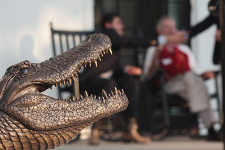 Journalism junior and current UF Theta Chi chapter brother Garrett Mastronardi, 20, talks with an FSU Theta Chi chapter alumnus Friday afternoon at the grand opening of the new Theta Chi house on UF’s campus. The new house cost about $4.3 million to build.
