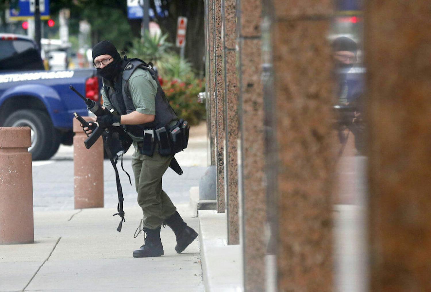 An armed shooter stands near the Earle Cabell Federal Building Monday, June 17, 2019, in downtown Dallas. The shooter was hit and injured in an exchange of gunfire with federal officers outside the courthouse.&nbsp;