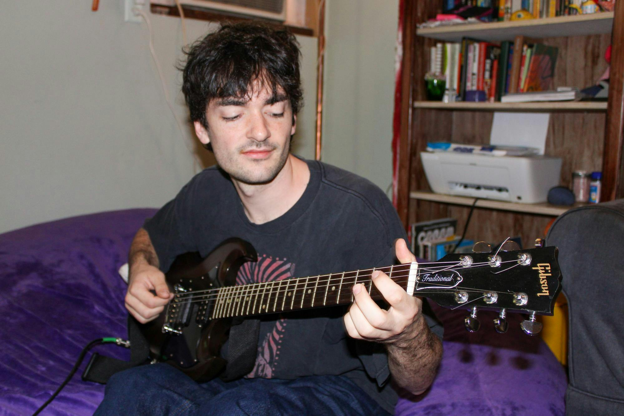 Luke Sechrest, a member of the local band Rustler, plays his guitar Friday, August 21, 2026, in Gainesville, Fla.