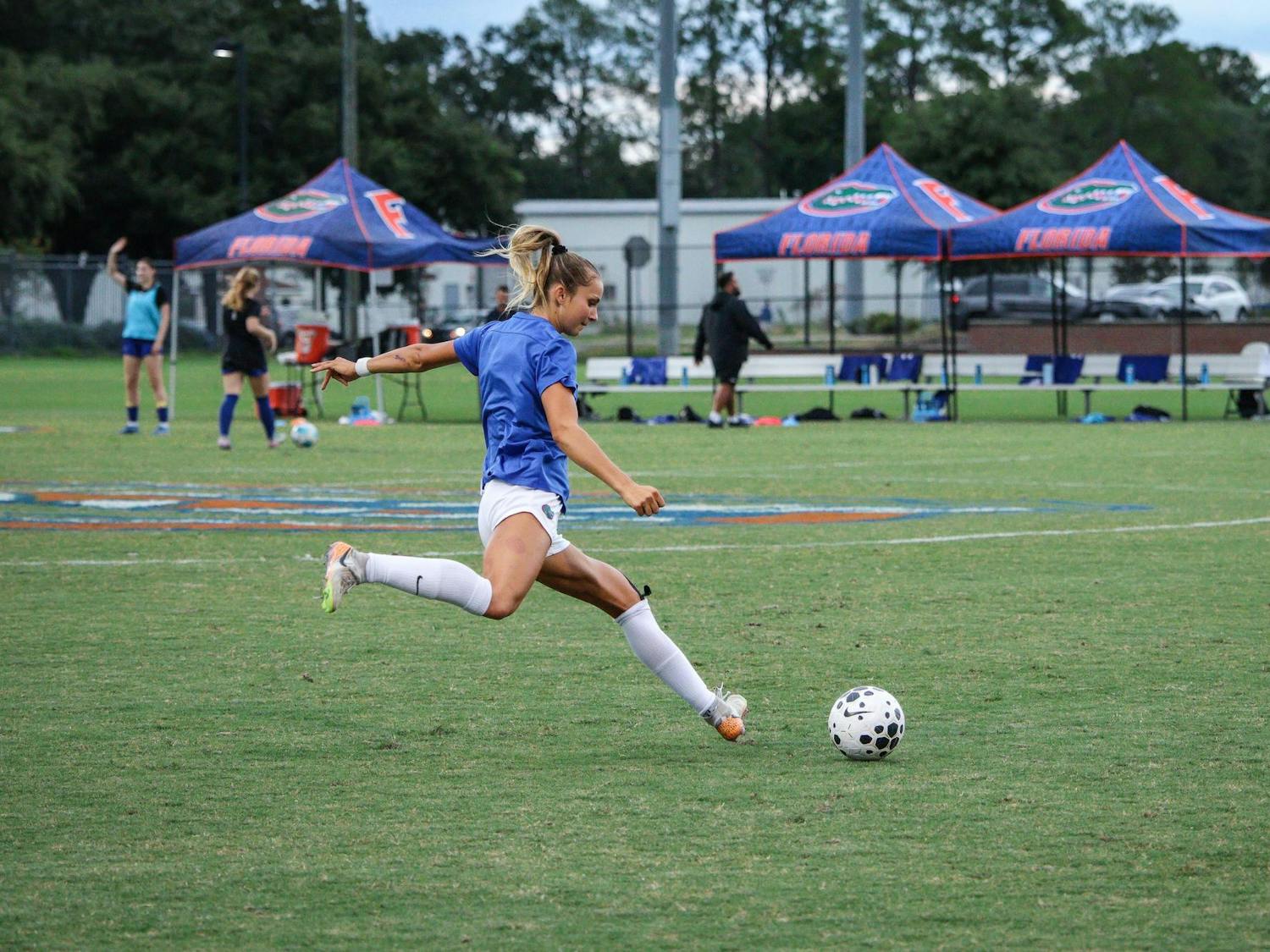 Player for the University of Florida Women's Soccer team practices shooting a goal.