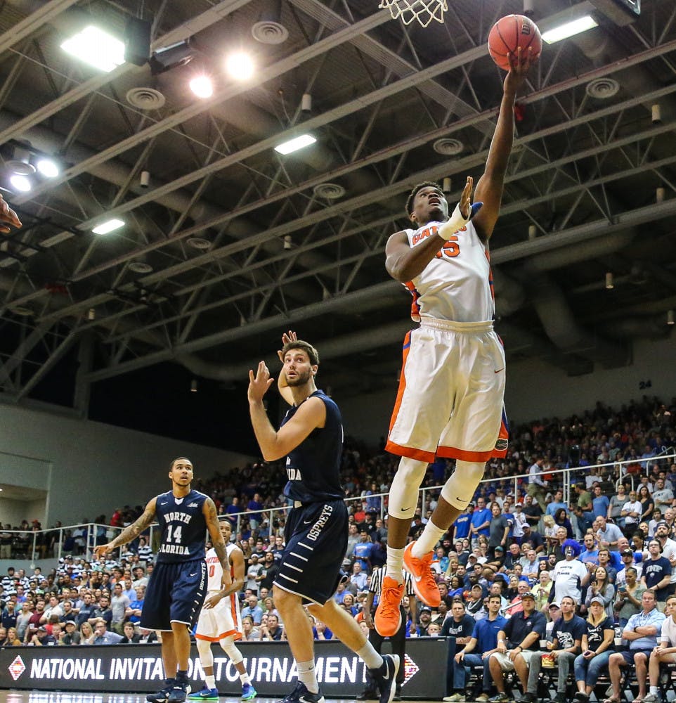 Florida center John Egbunu (15) lays the ball to the basket past North Florida guard Beau Beech (2) during NCAA college basketball action in the first round of the National Invitation Tournament (NIT) at the University of North Florida in Jacksonville, Fla., Tuesday, March 15, 2016. (Gary Lloyd McCullough/The Florida Times-Union via AP)
