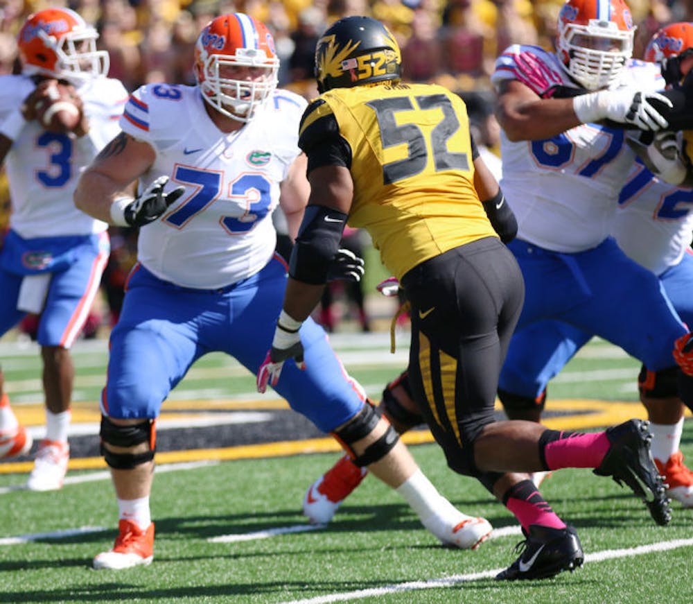 <p>Florida offensive lineman Tyler Moore (73) attempts to block Missouri defensive lineman Michael Sam (52), who leads the nation with nine sacks and 13 tackles for a loss, during the Gators’ 36-17 loss against the Tigers on Saturday at Faurot Field in Columbia, Mo. The UF offensive line surrendered six sacks to Missouri.</p>