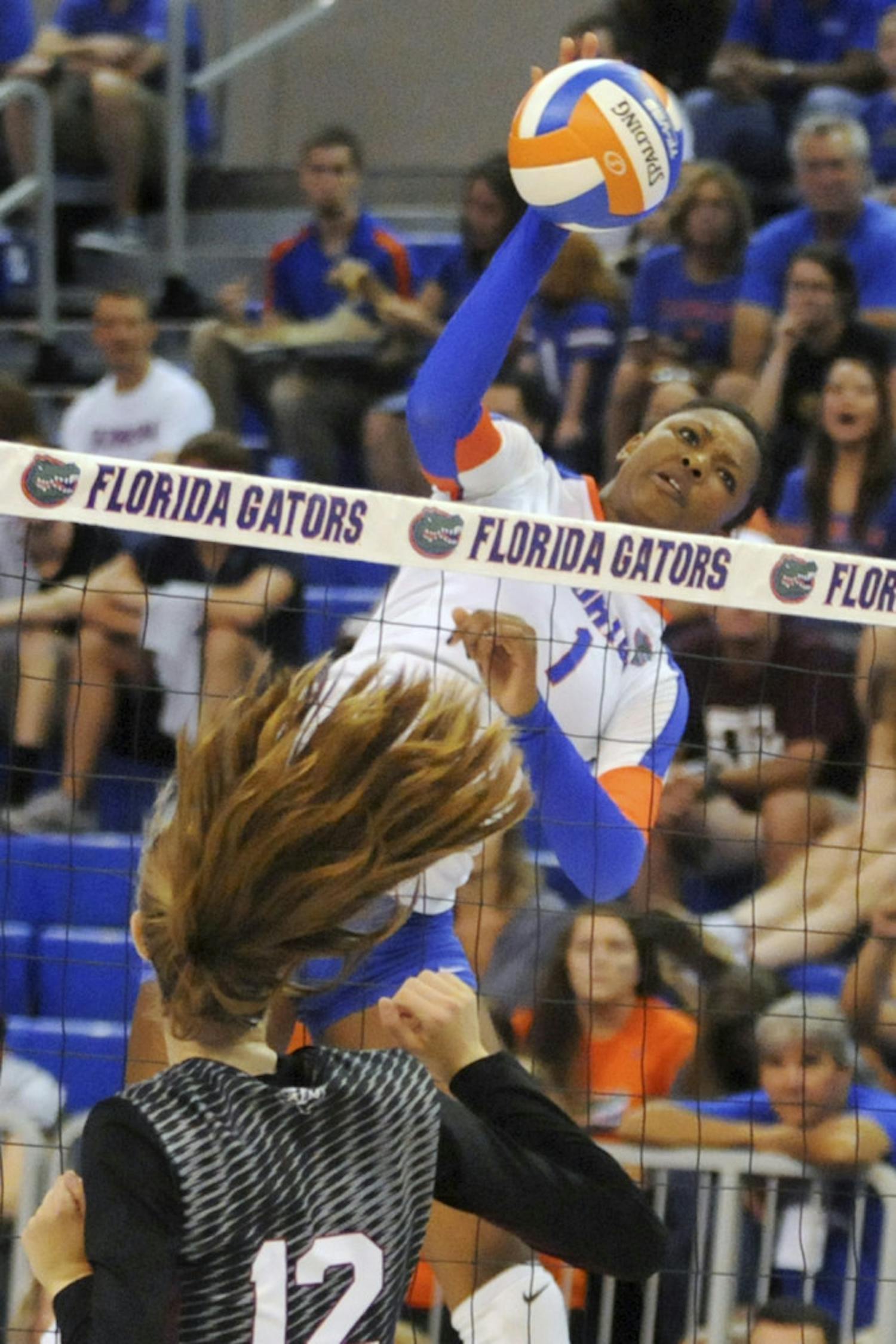 UF middle blocker Rhamat Alhassan swings for a kill attempt during Florida's 3-0 win against Texas A&amp;M on Oct. 3, 2015, in the O'Connell Center.