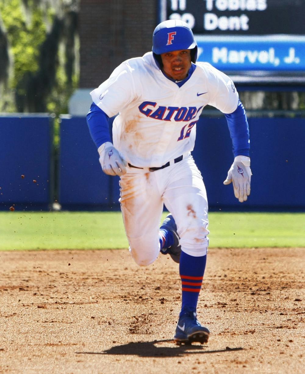 <p><span>Freshman shortstop Richie Martin attempts to steal third base during Florida’s 16-5 win against Duke on Sunday at McKethan Stadium. Martin left Florida's 6-3 series-clinching win against Miami on Sunday after beating hit by a pitch in the hand. </span></p>
<div><span><br /></span></div>