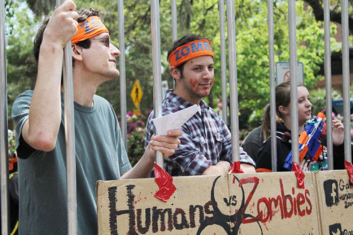 Robert Donaghy, a UF aerospace engineering sophomore, and Bernard Marger, a UF computer engineering sophomore, promote Humans vs. Zombies on Turlington Plaza.&nbsp;