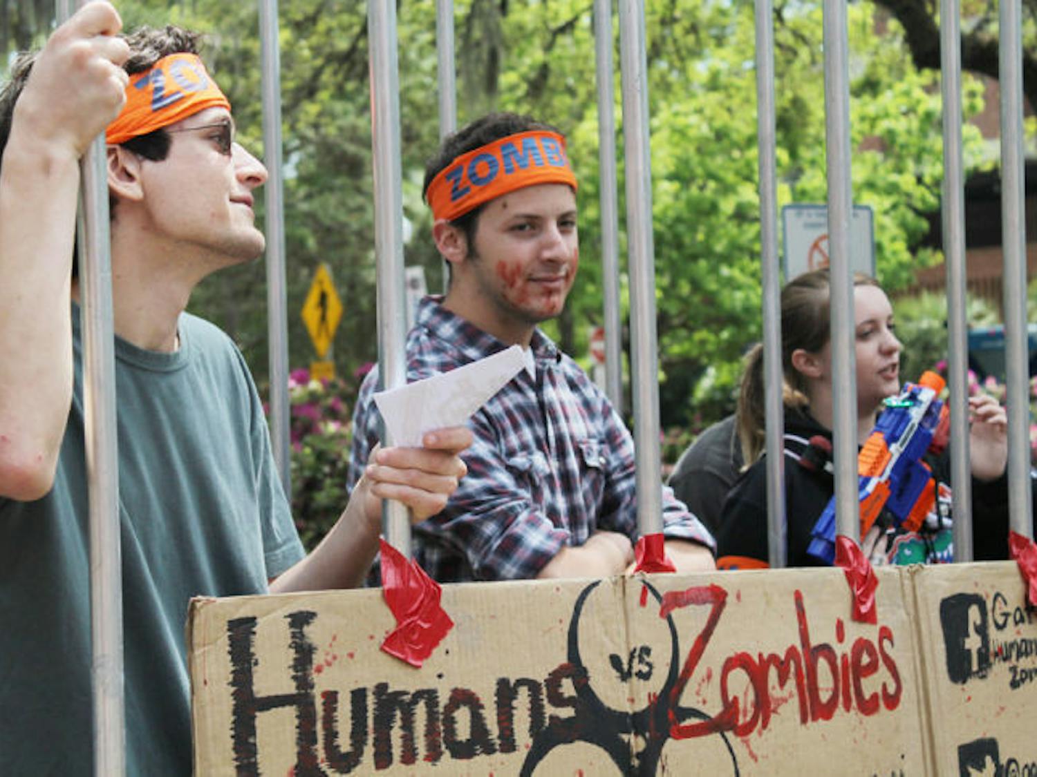 Robert Donaghy, a UF aerospace engineering sophomore, and Bernard Marger, a UF computer engineering sophomore, promote Humans vs. Zombies on Turlington Plaza.&nbsp;