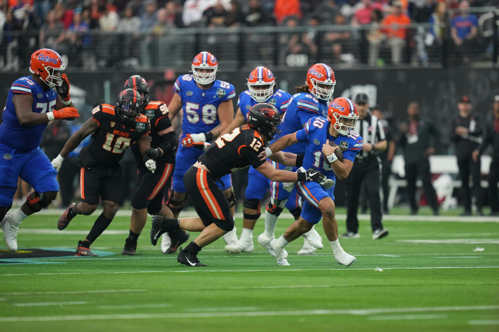 Florida quarterback Jack Miller III fights to ward off a tackle by an Oregon State defender in the Gators&#x27; loss Saturday, Dec. 17, 2022.(Photo by Al Powers / ESPN Images)